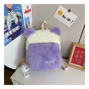 Close-up of plush purple and white backpack with embroidered logo and pom-pom charm
