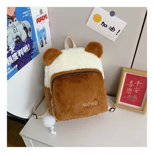 Close-up of fuzzy plush backpack featuring 3D ears and soft white faux fur texture