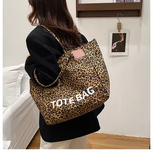 Macro shot of large leopard print tote bag detailing canvas texture and TOTE BAG lettering
