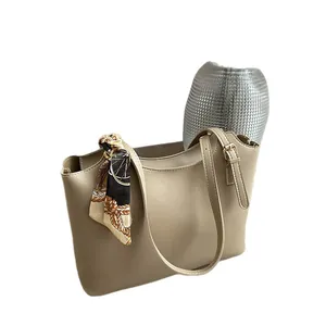 Minimalist beige tote bag with a decorative silk scarf on handle and spacious design
