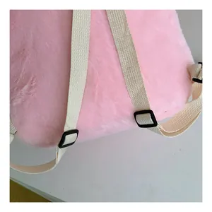 Close-up of pink faux fur texture and adjustable straps on the fluffy winter backpack