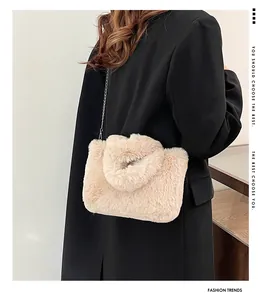 Detail shot of beige plush faux fur handbag with elegant silver metal chain strap