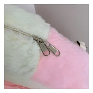 Close-up of dual metal zippers on pink and white plush backpack with soft faux fur texture