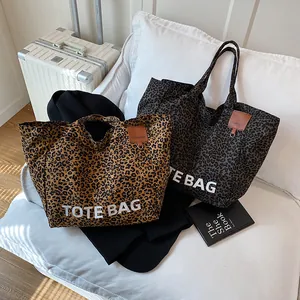 Large leopard print canvas tote bag in brown and grey with leather trim and dual handles