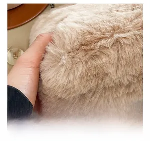Detailed close-up showing the soft beige faux fur texture and dense plush of this handbag
