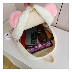 Detail of plush white and pink backpack interior showing large storage capacity