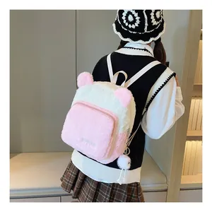 Detail of pink and white plush backpack with cute bear ears and embroidered logo