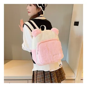 Detail of plush bear-eared backpack in pink and white faux fur with soft texture