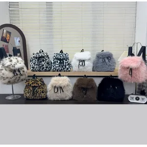 Collection of faux fur backpacks in leopard print and various solid colors with drawstring