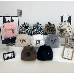 Collection of plush drawstring backpacks in solid colors and leopard prints on white display