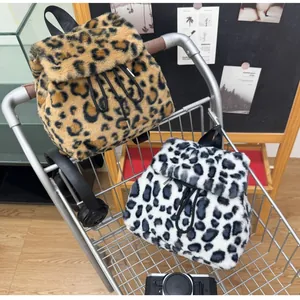 Detailed view of plush leopard print faux fur backpacks with drawstring closure in a cart