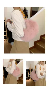 Detail of pink faux fur crescent bag with orange wooden beads and woven shoulder strap