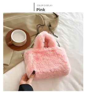 Detail of soft orange pink faux fur handbag with elegant metal chain on white background