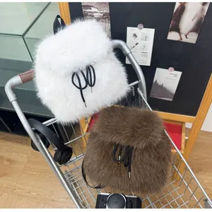 Detail of soft faux fur plush backpack in white and brown with black drawstring closure