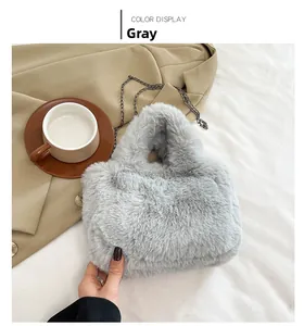 Detailed view of the soft grey faux fur texture and dark metal chain strap on this handbag