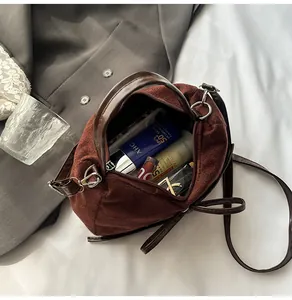 Vue intérieure du sac cabas en daim marron montrant l'espace pour téléphone et cosmétiques