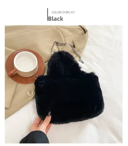 Detail view of the black fluffy faux fur handbag with a silver metal chain strap