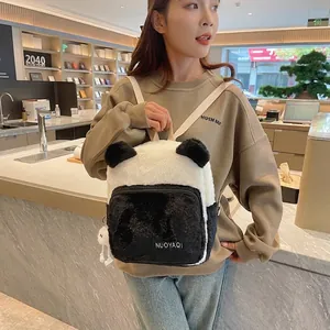 Detailed view of plush panda backpack showing soft faux fur texture and branded embroidery