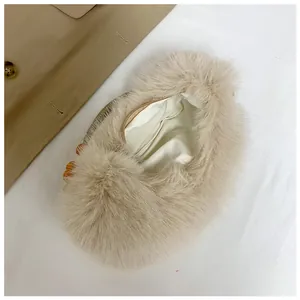 Detailed close-up of fluffy plush handbag with amber beaded handle and secure zipper