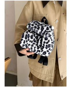 Close-up of black and white leopard print plush faux fur backpack with drawstring closure