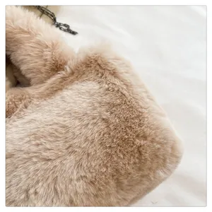 Close-up of soft khaki faux fur texture with elegant dark metal chain link detail