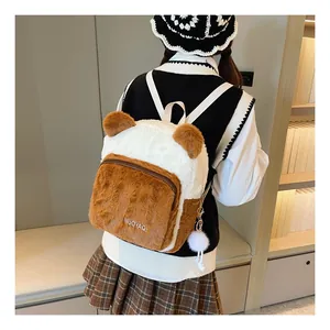 Detailed view of the soft plush bear backpack texture and side fuzzy ball keychain