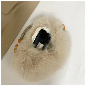 Inside view of a plush faux fur tote bag showing ample space for phone and makeup