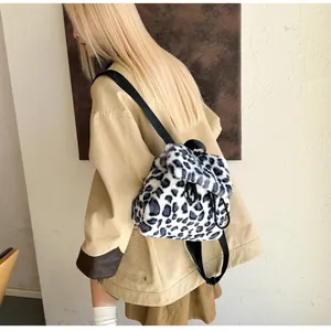 Close-up of leopard print faux fur backpack with drawstring closure and soft texture