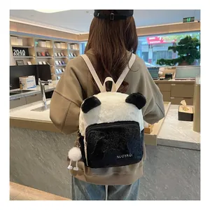 Detail of panda plush backpack with fluffy faux fur texture and branded embroidery