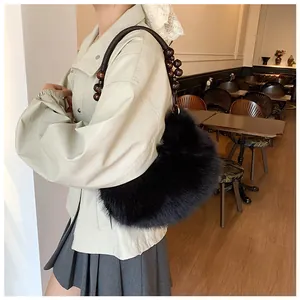 Close-up of black faux fur handbag with elegant dark brown wooden bead handle detail
