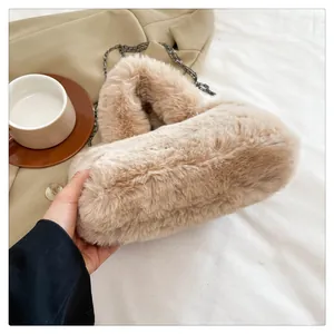 Detailed close-up of fluffy faux fur texture and metal chain on khaki crossbody bag