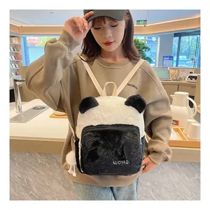Close-up of a panda-shaped plush backpack featuring fluffy black and white faux fur
