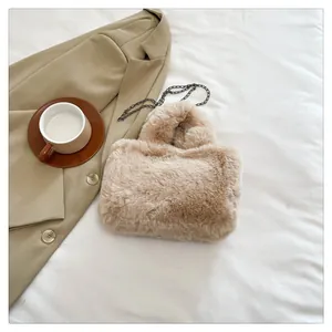 Detail of soft khaki faux fur handbag with elegant chain strap and plush texture