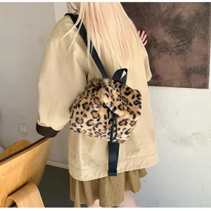 Detail view of plush faux fur backpack featuring brown leopard print and drawstring