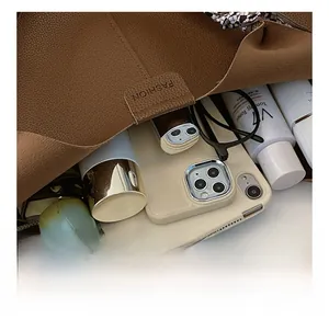 Detail view of brown leather tote bag interior showing large capacity and silk scarf