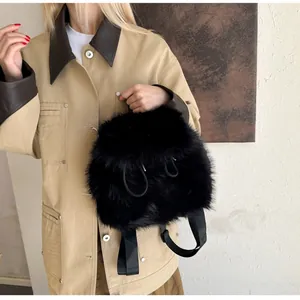 Close-up of black faux fur backpack with adjustable nylon drawstring and soft texture
