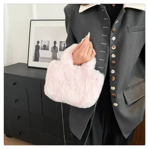 Detailed view of the soft pink fluffy faux fur handbag with elegant metal chain strap
