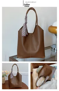 Close-up of coffee brown tote bag with pebble leather texture and fashion embossing
