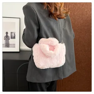 Detail of pink faux fur crossbody bag featuring soft plush texture and silver metal chain