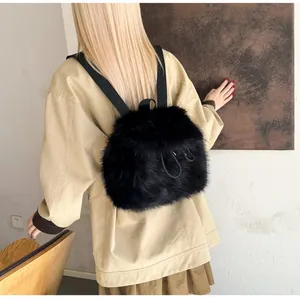 Close-up of black faux fur backpack featuring plush texture and drawstring straps