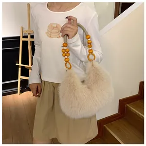 Detailed shot of beige faux fur shoulder bag with decorative yellow wooden beads