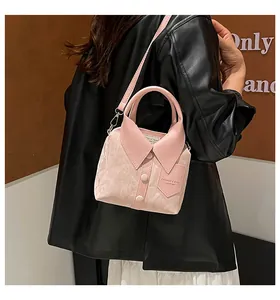 Detailed side view of pink crossbody bag with unique shirt collar design and silver hardware