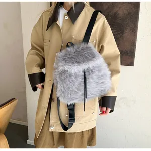 Detail of grey faux fur backpack with black drawstring closure and adjustable straps