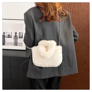 Back view of model wearing a fluffy white plush crossbody bag with a delicate metal chain