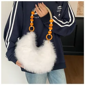 Detail of white plush faux fur handbag featuring unique beaded handle with orange wooden beads