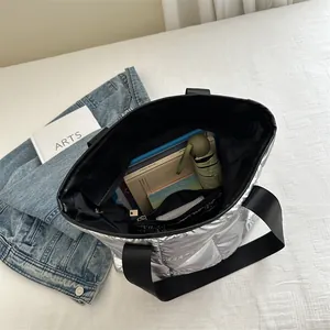 Metallic silver quilted puffer tote bag with large capacity and black strap handles