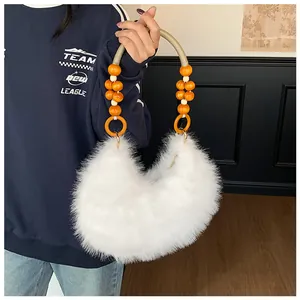 Detailed close-up of white plush handbag with decorative orange wooden bead handle