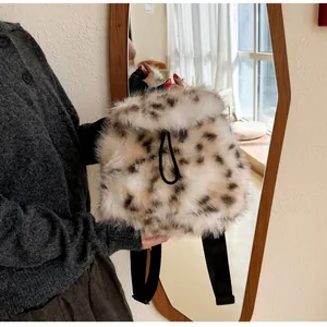 Detail of leopard print faux fur backpack with drawstring closure and wide fabric straps