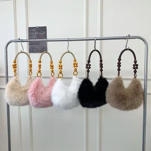 Plush faux fur crescent handbags with beaded handles in five stylish winter colors