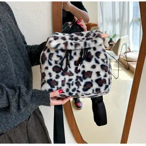 Detailed view of plush faux fur backpack with leopard print and black drawstring closure